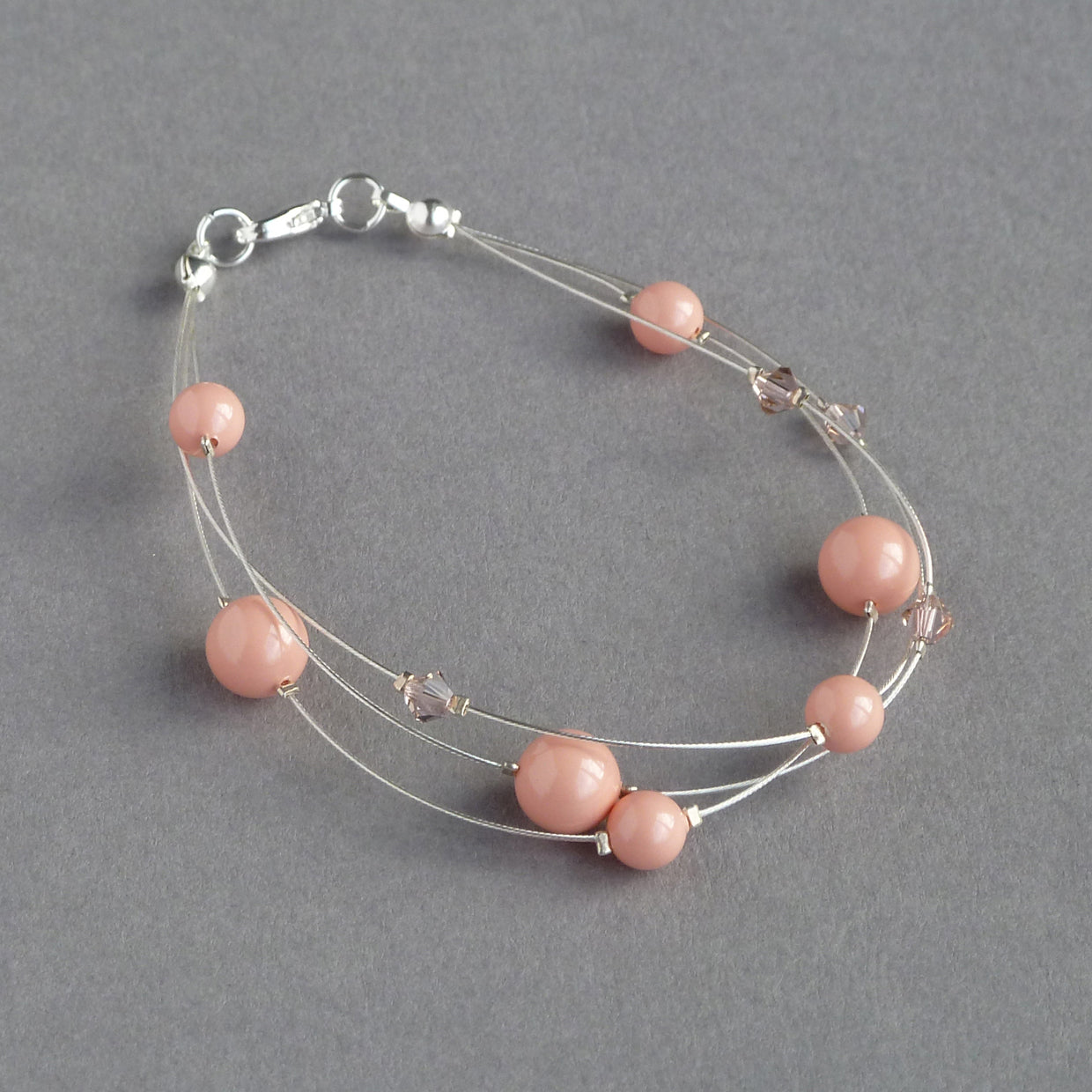 Coral pink floating pearl bracelet