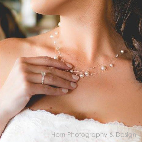 Dainty white floating pearl necklace being worn