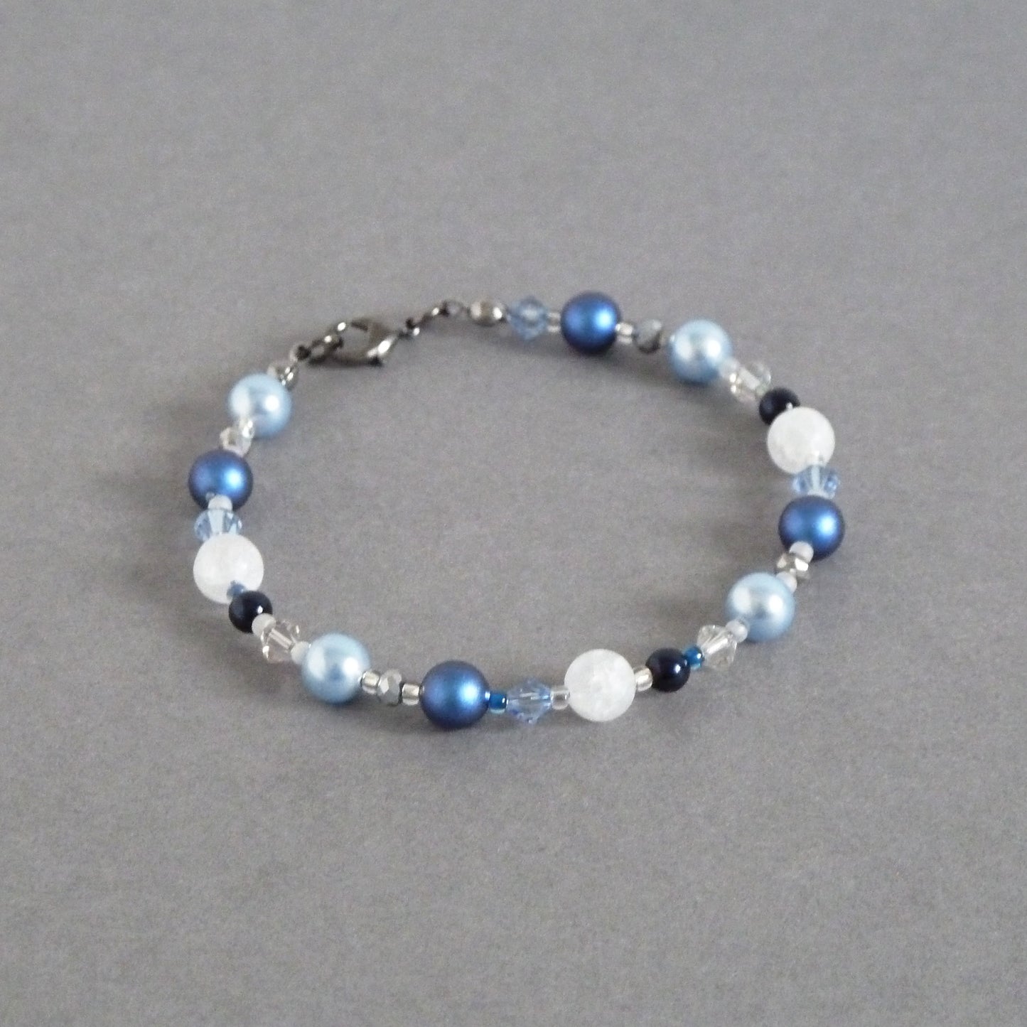 Mid blue pearl bracelet made with a mix of light blue, royal blue, navy and frosty white tones.