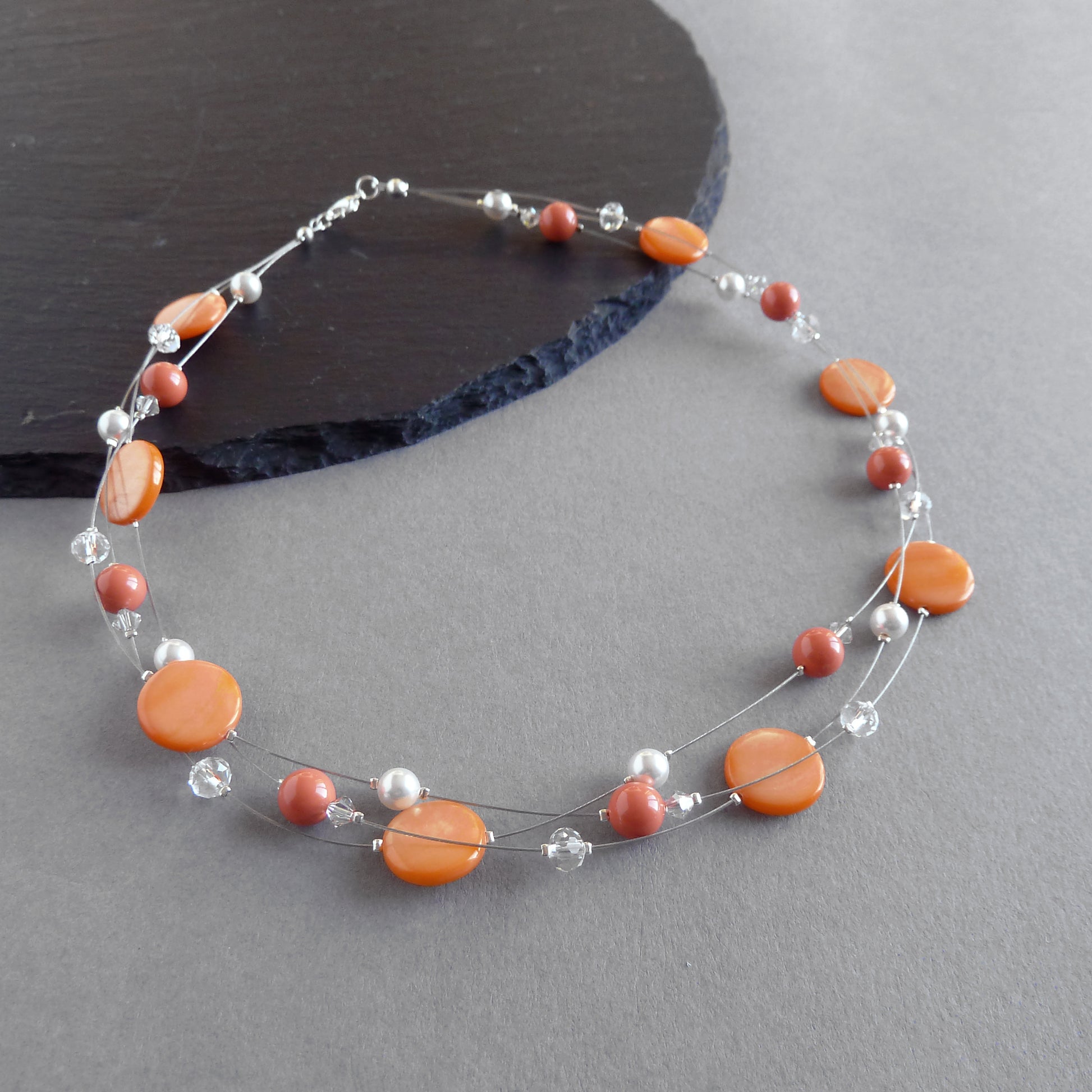 Orange three strand necklaces