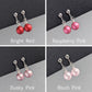 Pearl drop earrings with clip fittings in a range of red and pink shades