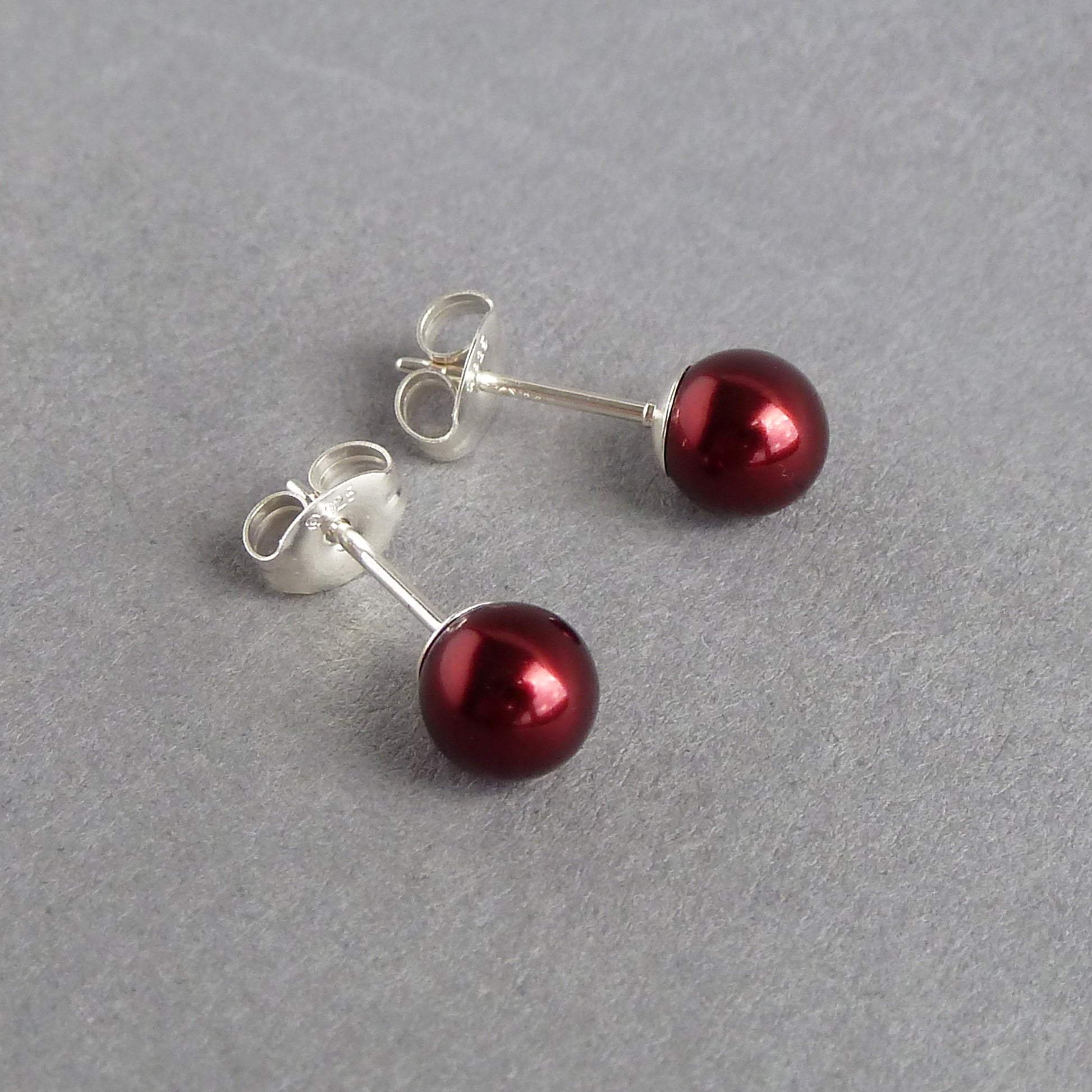 Round burgundy pearl stud earrings