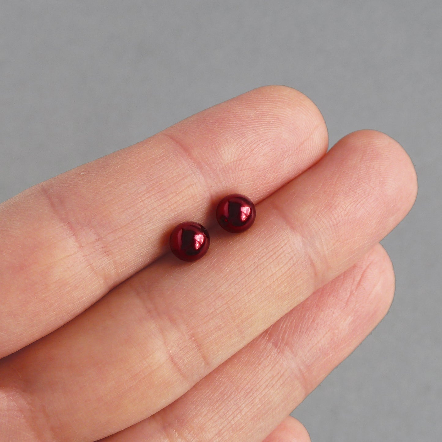 Dark red pearl stud earrings