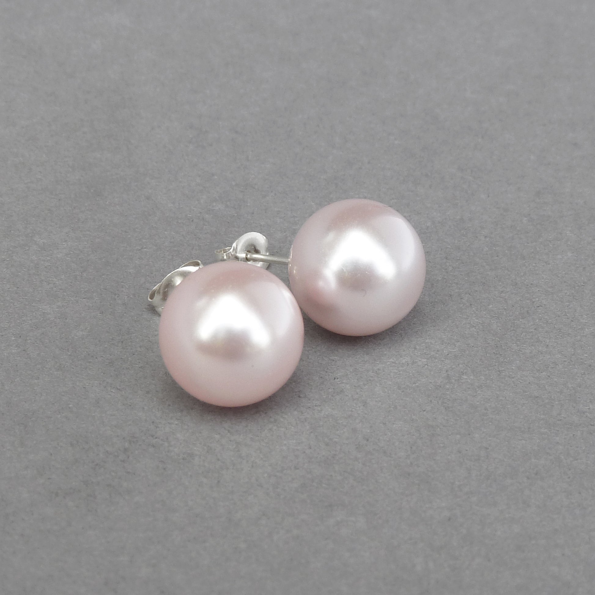 Large pale pink stud earrings
