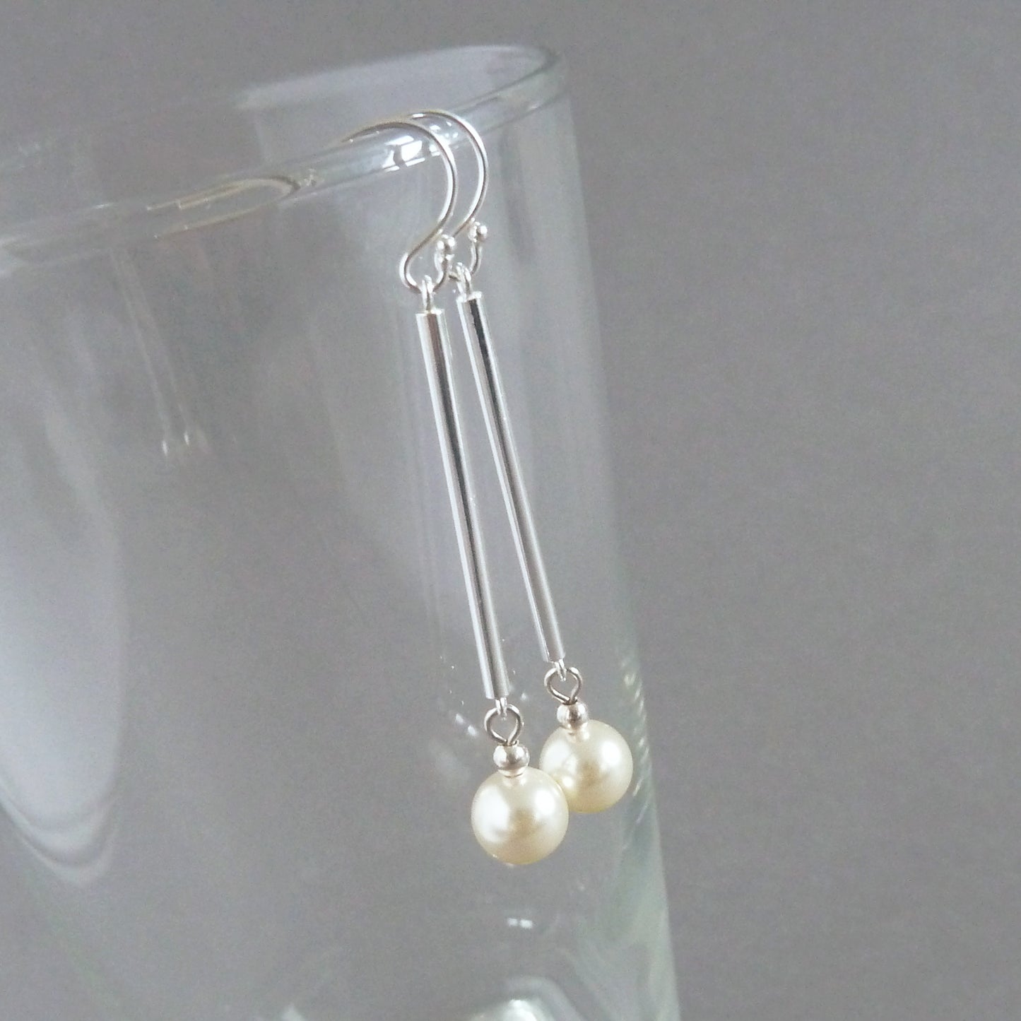 Long cream pearl drop earrings