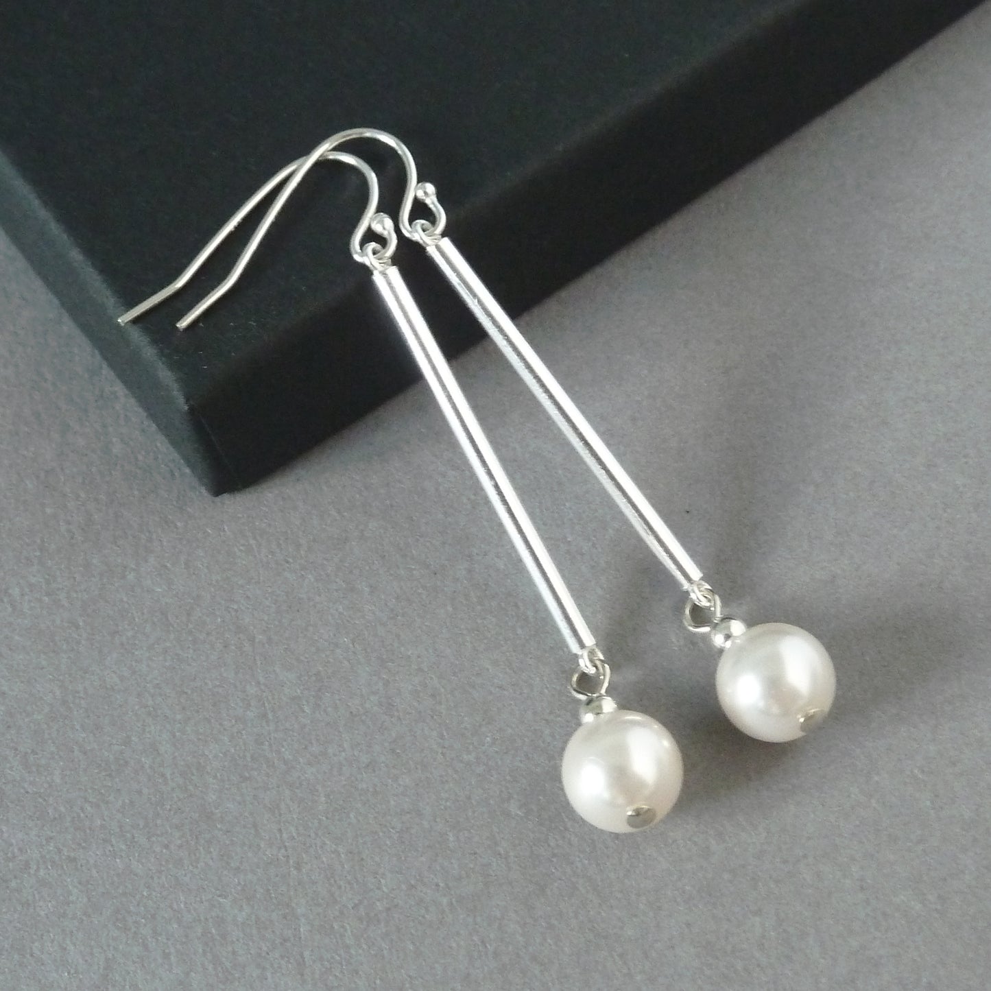 Dangly white pearl earrings with silver hooks