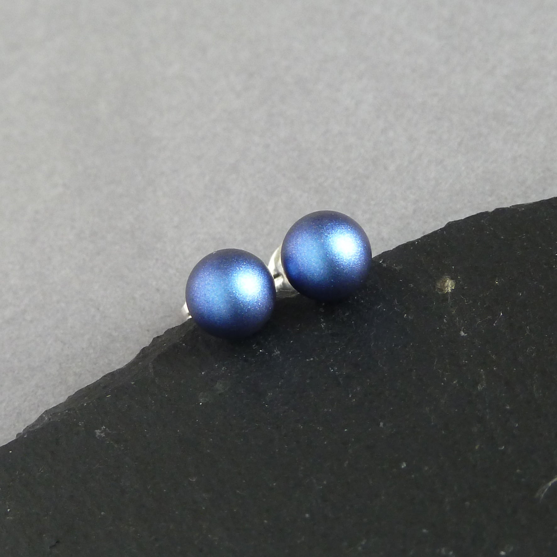 Round royal blue pearl stud earrings