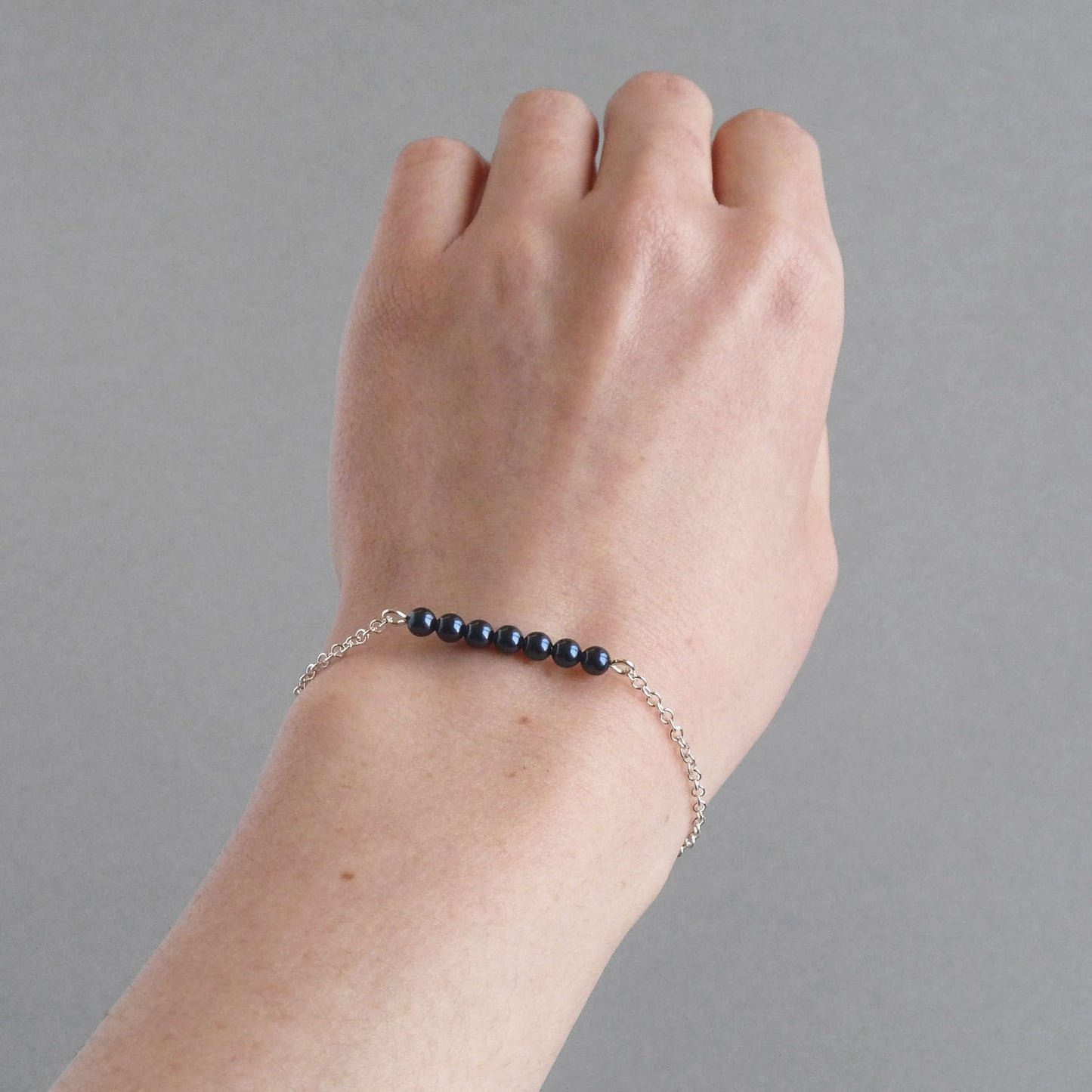 Silver chain and dark blue pearl bracelet