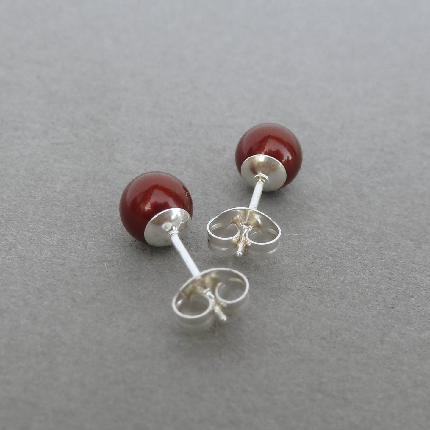 Small burgundy pearl stud earrings