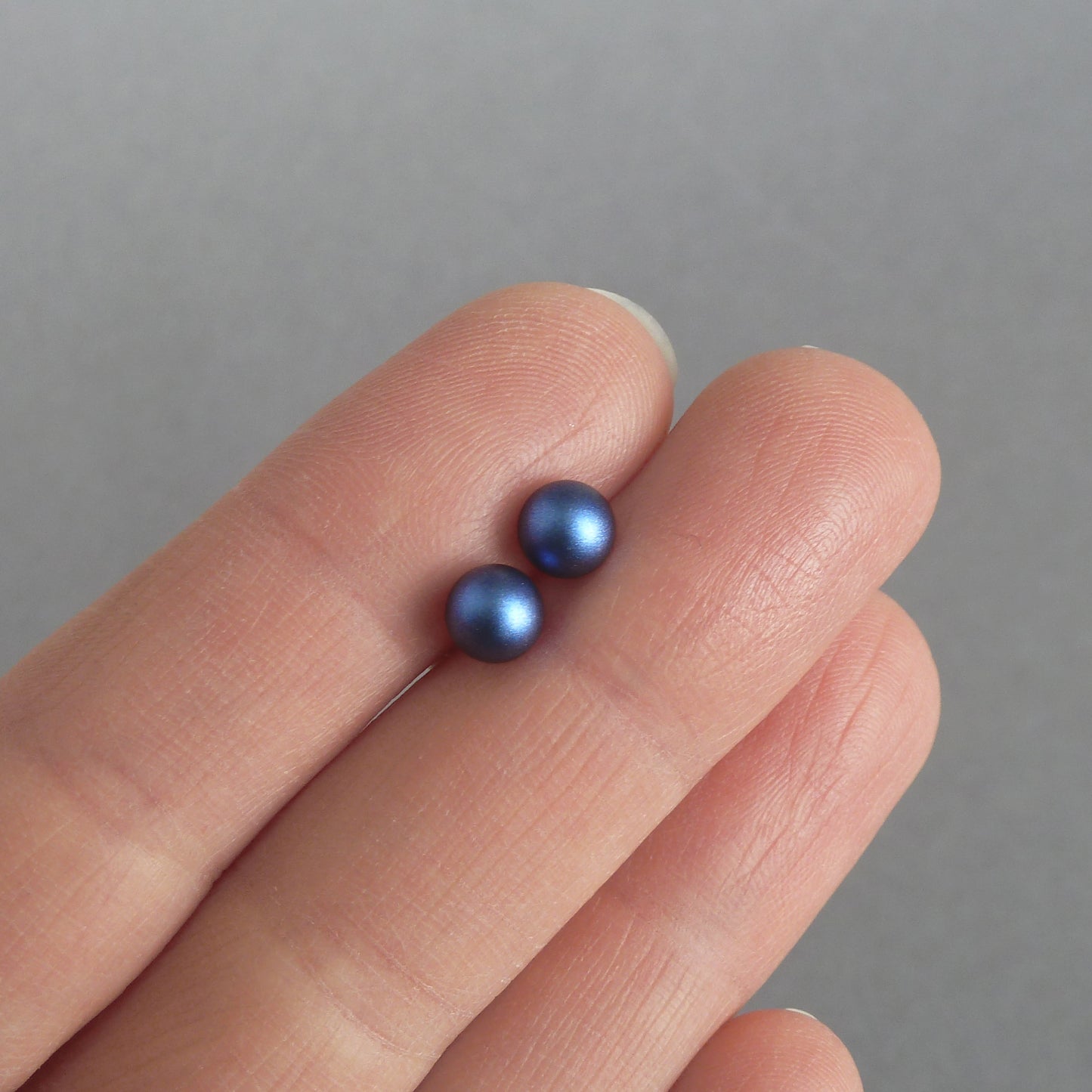 Small dark blue pearl stud earrings