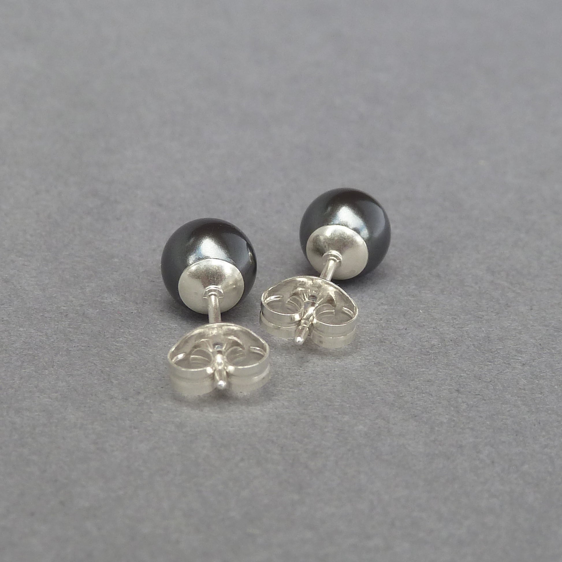 Small dark grey pearl stud earrings